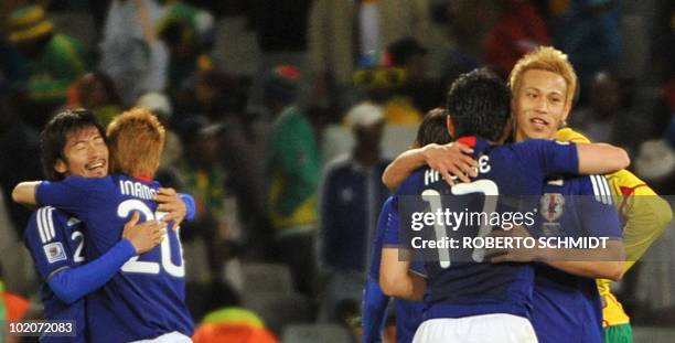 Japan's midfielder Makoto Hasebe and Japan's midfielder Keisuke Honda celebrate after their Group E first round 2010 World Cup football match on June...