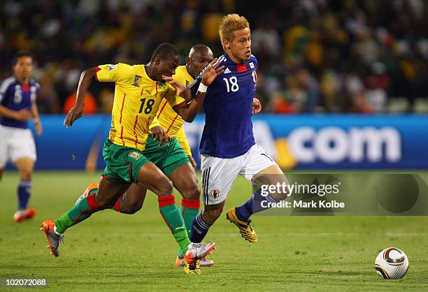 Enoh Eyong of Cameroon and Keisuke Honda of Japan battle for the ball the 2010 FIFA World Cup South Africa Group E match between Japan and Cameroon...