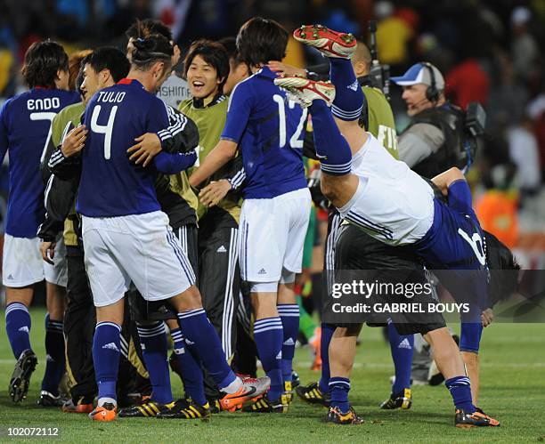 Japan player celebrate after their Group E first round 2010 World Cup football match on June 14, 2010 at Free State stadium in Mangaung/Bloemfontein....