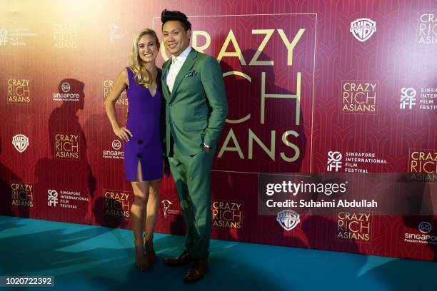 Director John M. Chu and wife attend the Singapore premiere of 'Crazy Rich Asians' on August 21, 2018 in Singapore.