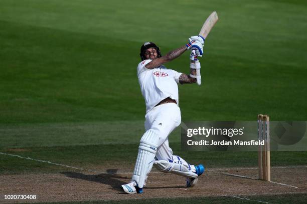 Jade Dernbach of Surrey hits out during day three of the Specsavers County Championship Division One match between Surrey and Lancashire at The Kia...