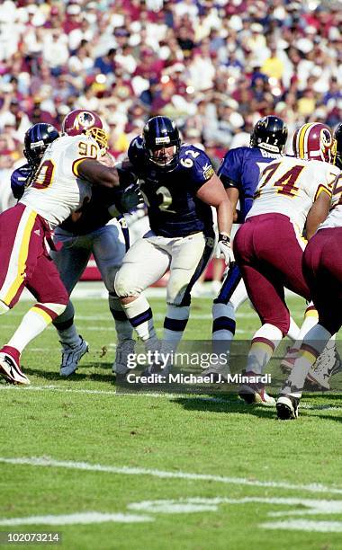 Offensive Lineman Mike Flynn of the Baltimore Ravens makes a hole for the offensive runner off of Defensive End Kenard Lang of the Washington...