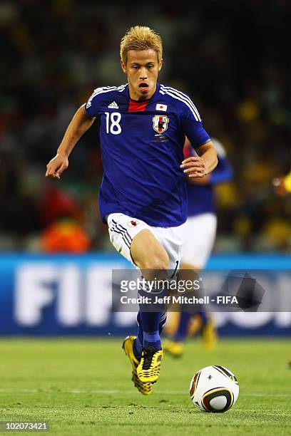 Keisuke Honda of Japan runs with the ball during the 2010 FIFA World Cup South Africa Group E match between Japan and Cameroon at the Free State...