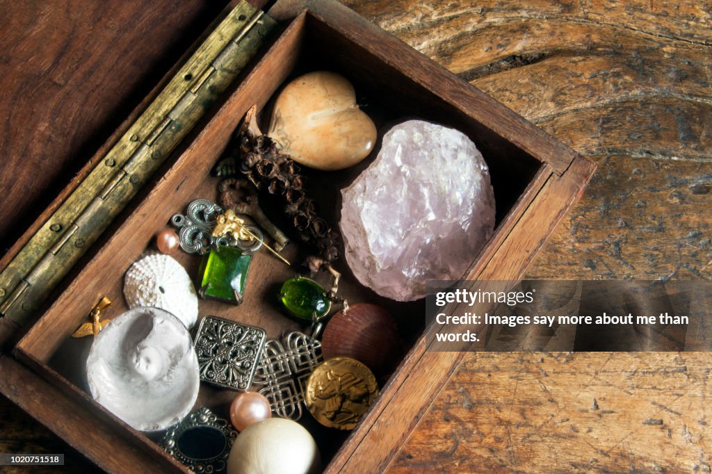 An old box with many diferent objects like a girl‘s treasure box. Still life.