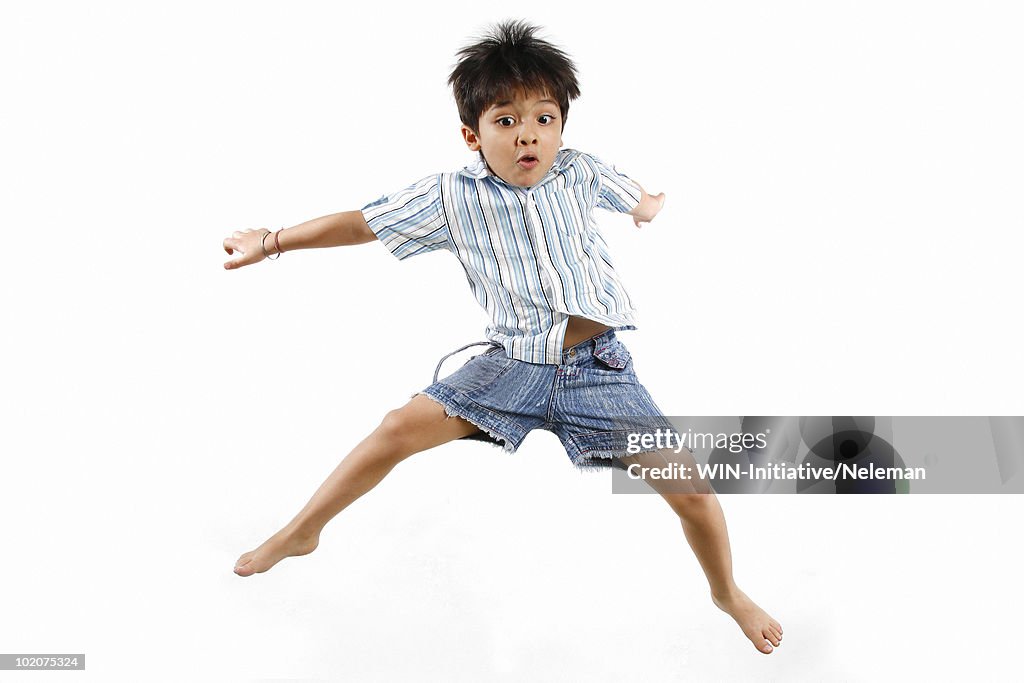 Boy jumping with his legs apart