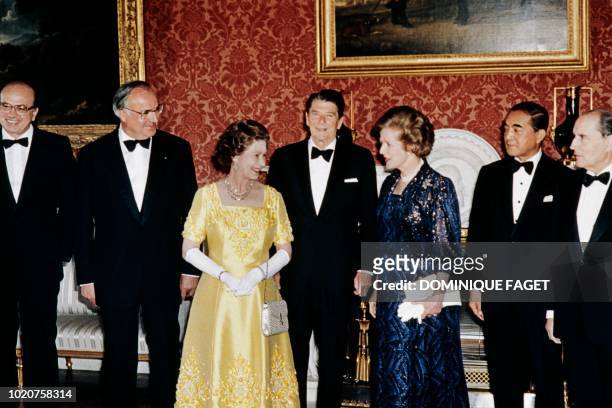 Britain's Queen Elizabeth II poses on September 6, 1984 at Buckingham Palace with Economic Summit leaders: French President François Mitterrand,...