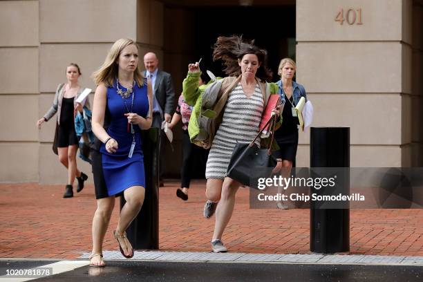 Journalists run out of the Albert V. Bryan U.S. Courthouse during the trial of former Trump campaign chairman Paul Manafort during the fourth day of...