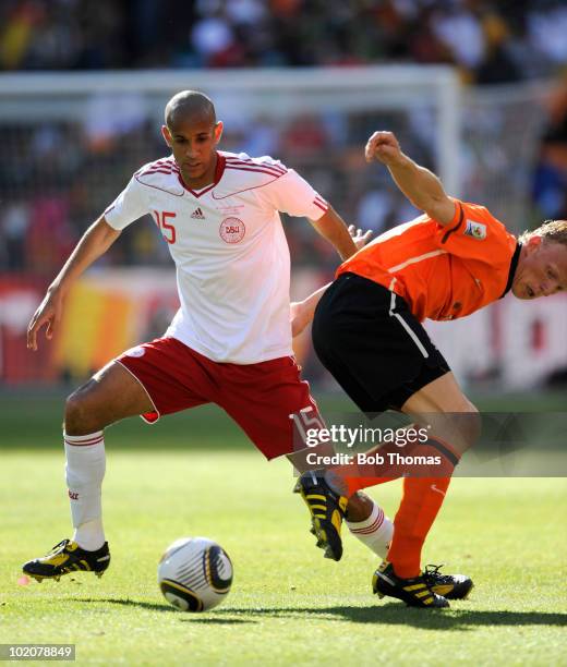 Simon Poulsen of Denmark with Dirk Kuyt of the Netherlands during the 2010 FIFA World Cup Group E match between Netherlands and Denmark at Soccer...