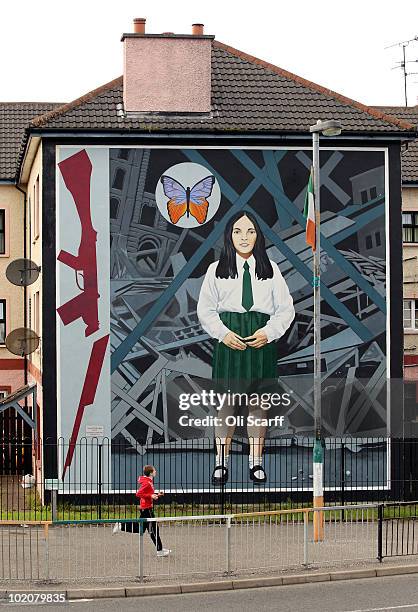 Boy runs past a mural in the Bogside area of Londonderry close to where the Bloody Sunday killings took place in 1972 on June 14, 2010 in...