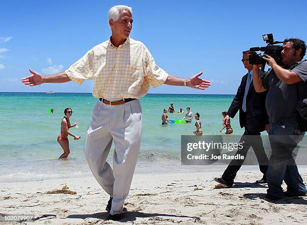 Florida Gov. Charlie Crist is followed by the media as he claims that Miami Beach is clean and free of oil on June 14, 2010 in Miami Beach, Florida....