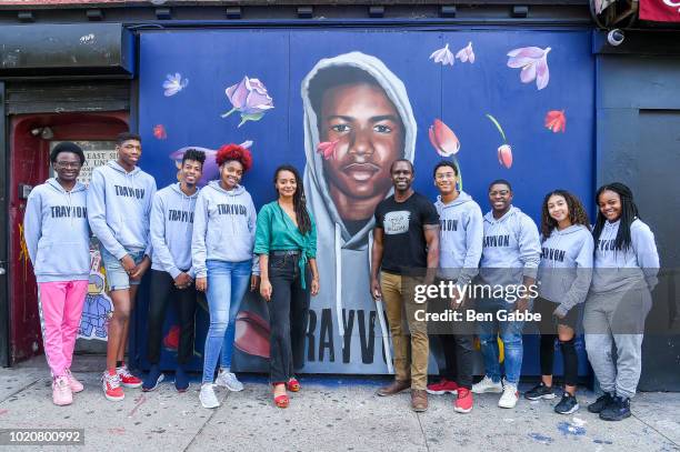 Mural artist Tatyana Fazlalizadeh and actor/owner of Liberated People Gbenga Akinnagbe surrounded by kids from the non-profit organization The Door...