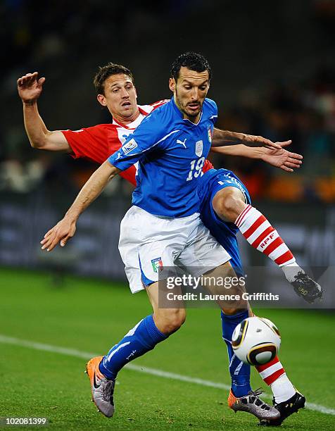 Gianluca Zambrotta of Italy is challenged by Jonathan Santana of Paraguay during the 2010 FIFA World Cup South Africa Group F match between Italy and...