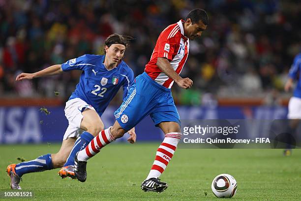 Riccardo Montolivo of Italy chases Paulo Da Silva of Paraguay during the 2010 FIFA World Cup South Africa Group F match between Italy and Paraguay at...