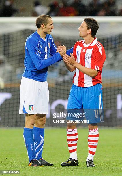 Giorgio Chiellini of Italy shakes hands with Jonathan Santana of Paraguay after their teams drew 1-1 in the 2010 FIFA World Cup South Africa Group F...
