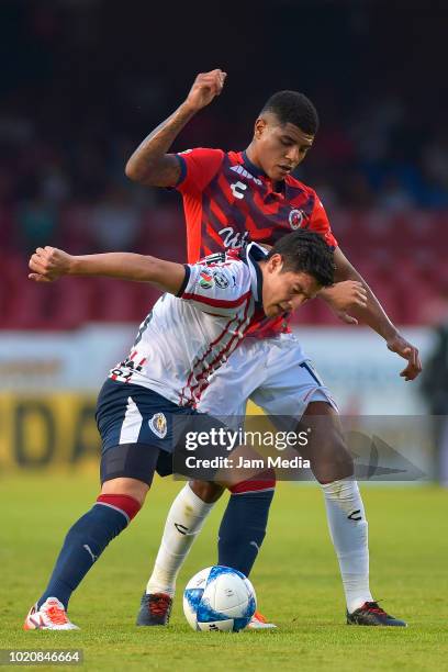 Wilder Cartagena of Veracruz fights for the ball with Michael Perez of Chivas during a fifth round match between Veracruz and Chivas as part of...