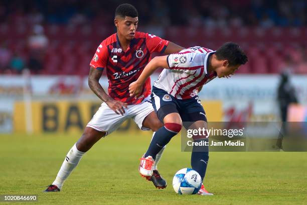 Wilder Cartagena of Veracruz fights for the ball with Michael Perez of Chivas during a fifth round match between Veracruz and Chivas as part of...