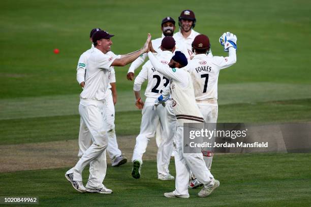 Amar Virdi and Will Jacks of Surrey celebrate with their teammates after dismissing Shivnarine Chanderpaul of Lancashire during day three of the...