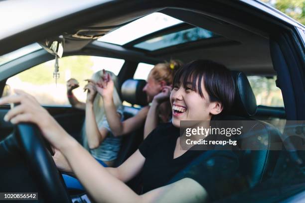 group of young multi-ethnic women enjoying road trip - land vehicle stock pictures, royalty-free photos & images