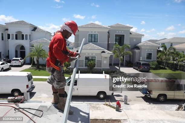 Diego Perez works on a Toll Brothers home on August 21, 2018 in Boca Raton, Florida. Toll Brothers topped Wall Street estimates for quarterly profit,...