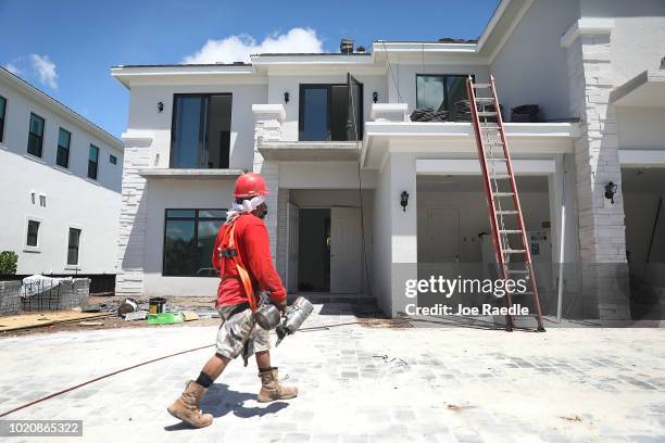 Diego Perez works on a Toll Brothers home on August 21, 2018 in Boca Raton, Florida. Toll Brothers topped Wall Street estimates for quarterly profit,...