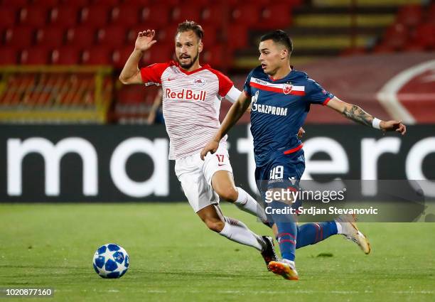 Nemanja Radonjic of Crvena Zvezda in against Andreas Ulmer of Red Bull Salzburg during the UEFA Champions League Play Off First Leg match between FK...