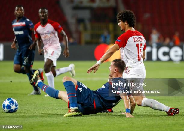 Nikola Stojiljkovic of Crvena Zvezda in against Andre Ramalho of Red Bull Salzburg during the UEFA Champions League Play Off First Leg match between...