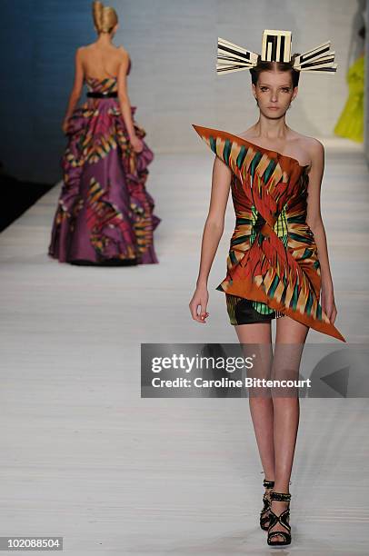 Model displays a design by Andre Lima during the sixth day of Sao Paulo Fashion Week Summer 2011 at Bienal pavilion on June 14, 2010 in Sao Paulo,...