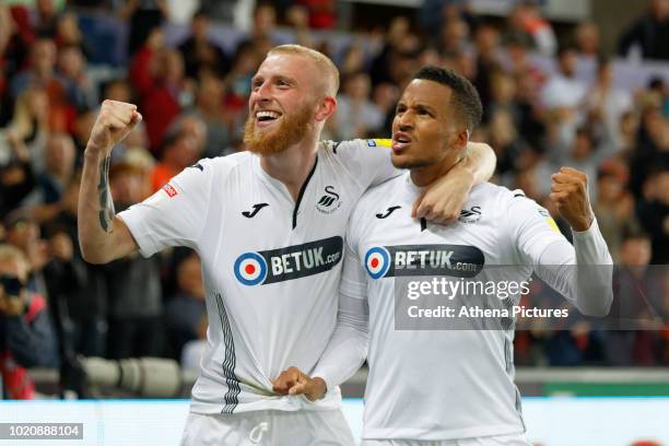 Oli McBurnie of Swansea City celebrates his second goal with team mate Martin Olsson during the Sky Bet Championship match between Swansea City and...