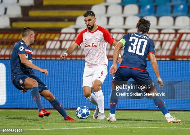 Munas Dabbur of Red Bull Salzburg in action against Nenad Krsticic and Filip Stojkovic of Crvena Zvezda during the UEFA Champions League Play Off...