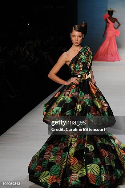 Model displays a design by Andre Lima during the sixth day of the Sao Paulo Fashion Week Summer 2011 at Bienal pavilion on June 14, 2010 in Sao...