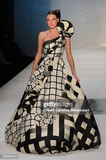 Model displays a design by Andre Lima during the sixth day of the Sao Paulo Fashion Week Summer 2011 at Bienal pavilion on June 14, 2010 in Sao...