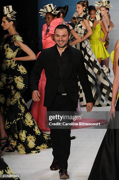 Fashion designer Andre Lima greets the audience at the end of his fashion show during the sixth day of the Sao Paulo Fashion Week Summer 2011 at the...