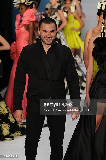 Fashion designer Andre Lima greets the audience at the end of his fashion show during the sixth day of the Sao Paulo Fashion Week Summer 2011 at the...