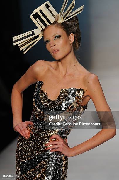 Model displays a design by Andre Lima during the sixth day of the Sao Paulo Fashion Week Summer 2011 at Bienal pavilion on June 14, 2010 in Sao...