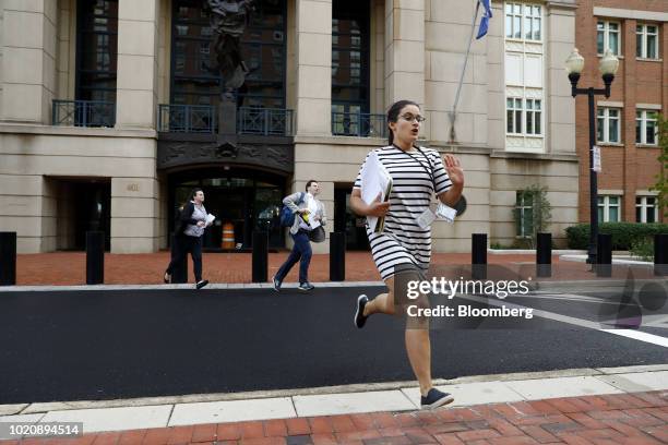 Members of the media run while exiting from District Court in Alexandria, Virginia, U.S., on Tuesday, Aug. 21, 2018. A federal jury convicted Paul...