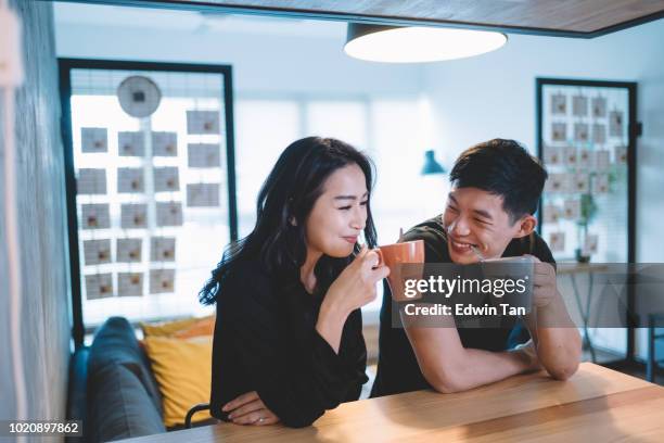 asian chinese couple at the dining chatting bonding time while having their coffee in the morning - asian wife stock pictures, royalty-free photos & images