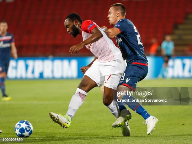 Reinhold Yabo of Red Bull Salzburg in action against Milan Rodic of Crvena Zvezda during the UEFA Champions League Play Off First Leg match between...