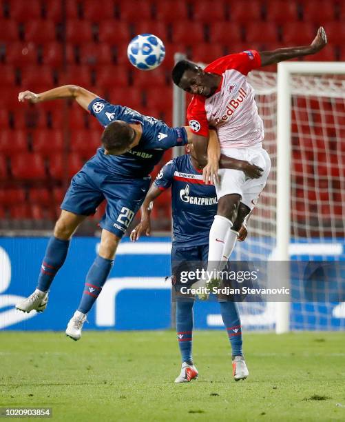 Amadou Haidara of Red Bull Salzburg jump for the ball against Dusan Jovancic of Crvena Zvezda during the UEFA Champions League Play Off First Leg...