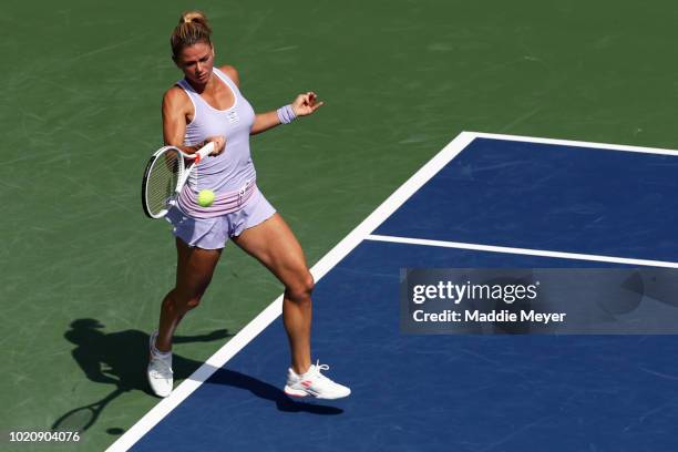 Camila Giorgi of Italy returns a shot to Belinda Bencic of Switzerland during Day 2 of the Connecticut Open at Connecticut Tennis Center at Yale on...