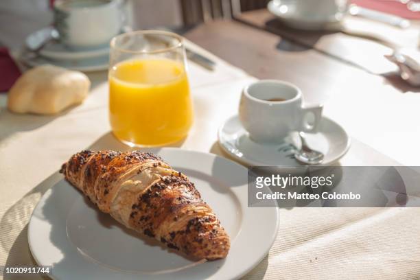 typical italian breakfast, short black coffee, croissant and orange juice - coffee table stock pictures, royalty-free photos & images