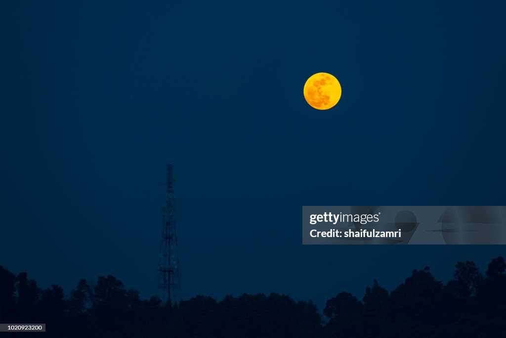 Moon rise over telecommunication tower in Ampang, Malaysia.