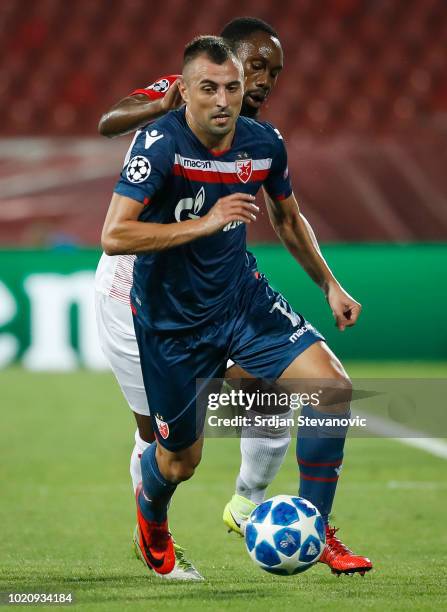 Nenad Krsticic of Crvena Zvezda in action against Reinhold Yabo of Red Bull Salzburg during the UEFA Champions League Play Off First Leg match...