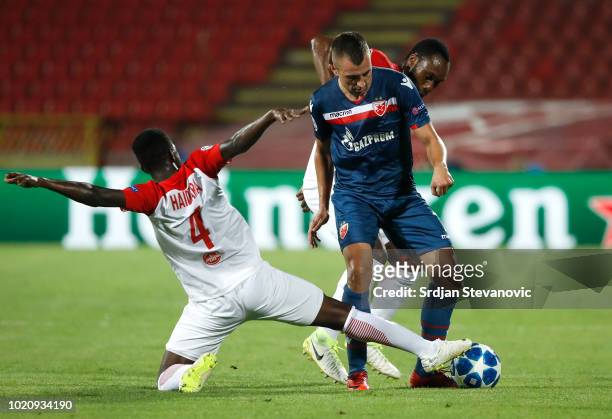 Nenad Krsticic of Crvena Zvezda in action against Amadou Haidara and Reinhold Yabo of Red Bull Salzburg during the UEFA Champions League Play Off...