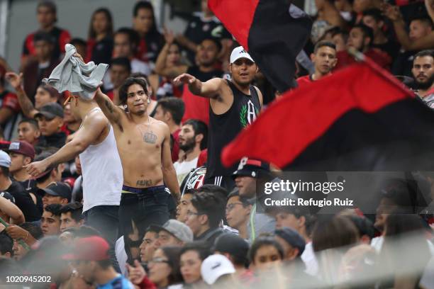 Fans of Atlas cheer during the fifth round match between Atlas and Morelia as part of the Torneo Apertura 2018 Liga MX at Jalisco Stadium on August...