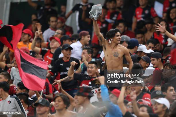 Fans of Atlas cheer during the fifth round match between Atlas and Morelia as part of the Torneo Apertura 2018 Liga MX at Jalisco Stadium on August...