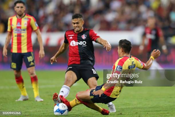 Andrés Andrade of Atlas fights for the ball with Jorge Valadéz of Morelia during the fifth round match between Atlas and Morelia as part of the...