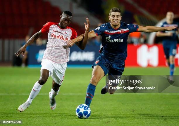 Patson Daka of Red Bull Salzburg in action against Srdjan Babic of Crvena Zvezda during the UEFA Champions League Play Off First Leg match between FK...