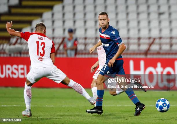 Veljko Simic of Crvena Zvezda in action against Hannes Wolf of Red Bull Salzburg during the UEFA Champions League Play Off First Leg match between FK...