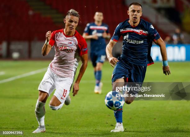 Hannes Wolf of Red Bull Salzburg competes for the ball against Milan Rodic of Crvena Zvezda during the UEFA Champions League Play Off First Leg match...