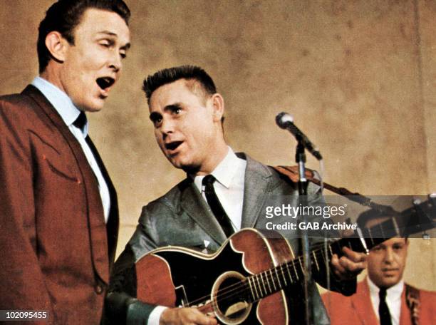 Photo of Country Music singer s Jimmy Dean and George Jones performing live on stage in the early 1960's